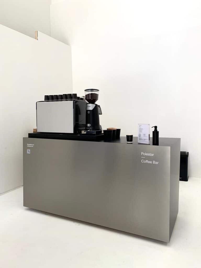 Polestar branded coffee bar by Tom’s Coffee with espresso machine and grinder at a launch event