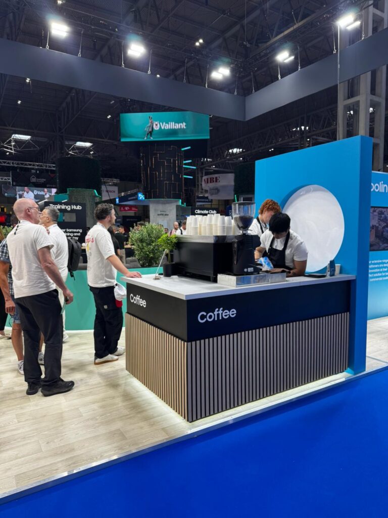 Professional event baristas operating a high-volume coffee station at an exhibition